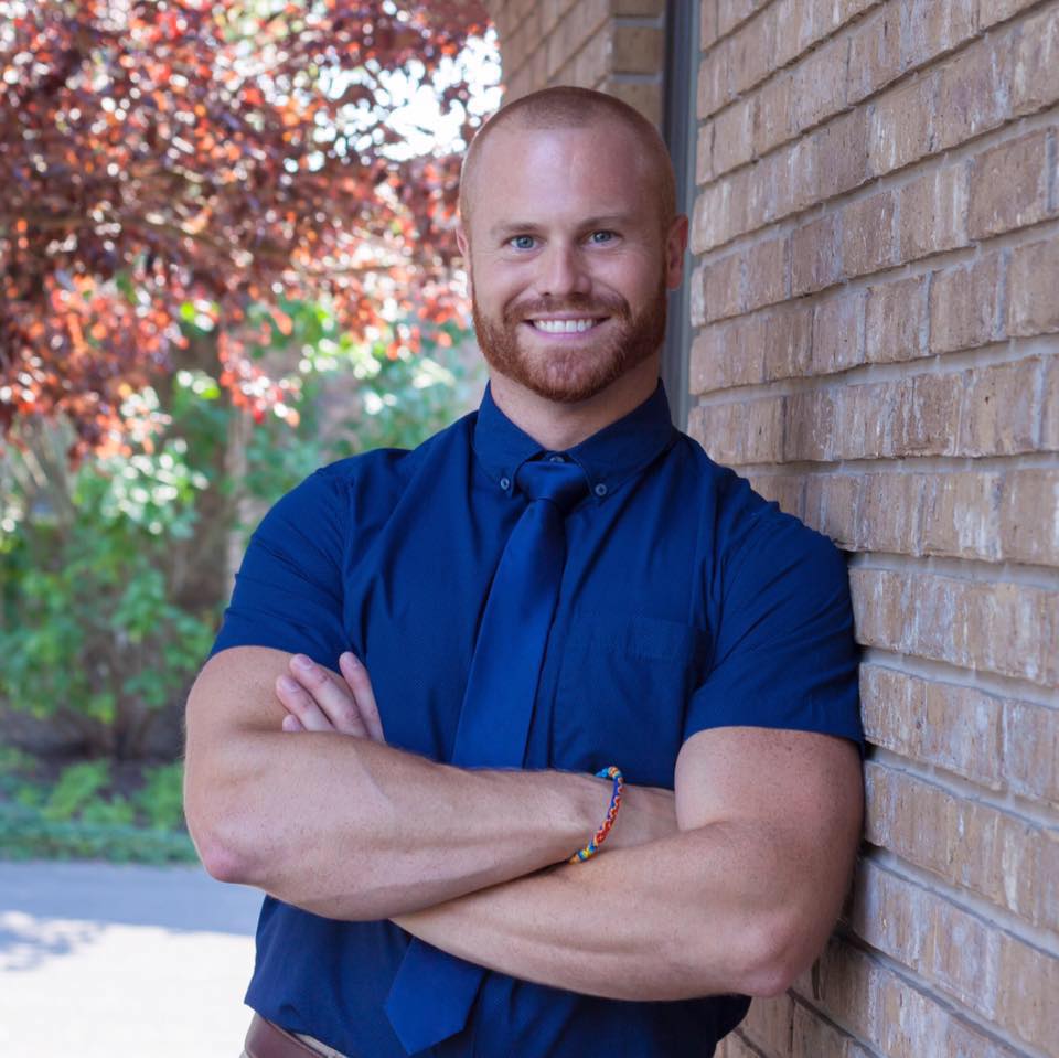 Dr. Russell D. Tritapoe DDS professional portrait leaning against wall