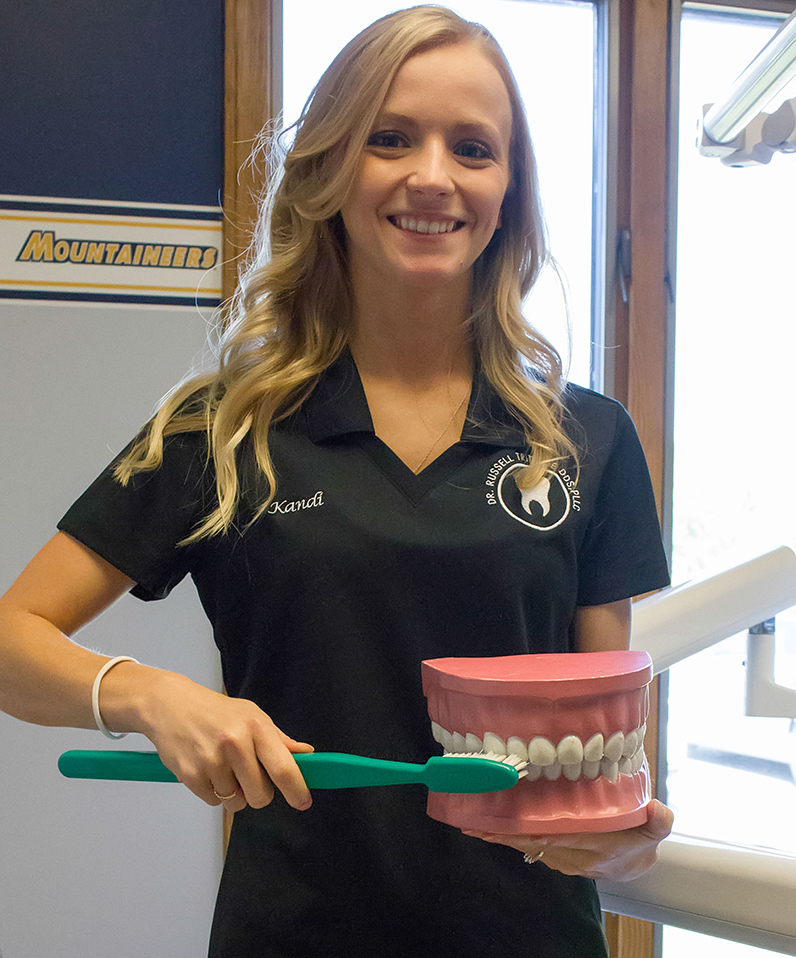 employee demonstrating brushing teeth