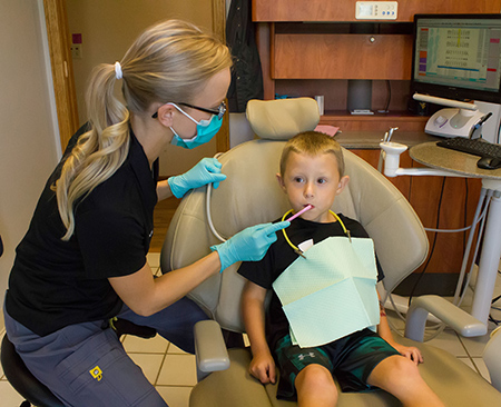 Little boy getting teeth cleaned