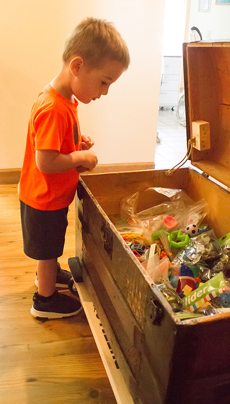 Little boy looking in treasure chest