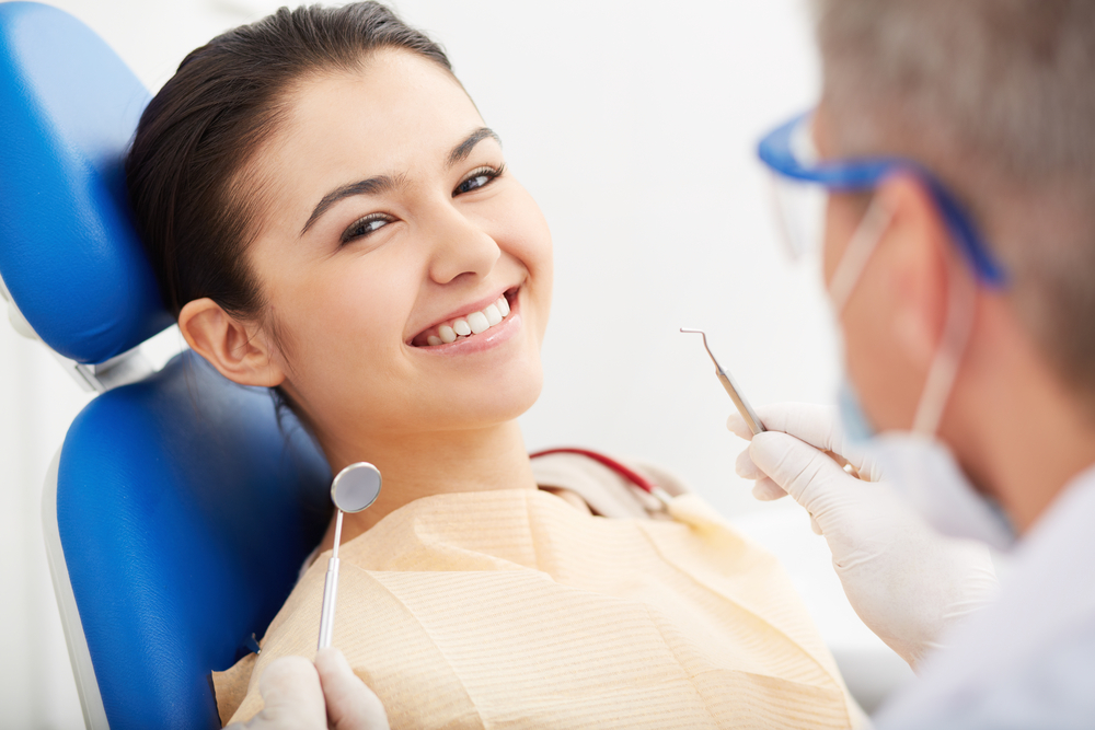 Girl in dentist chair smiling